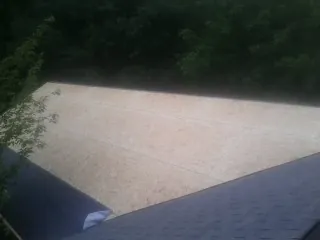 New OSB roof sheathing installed beside an existing shingle roof in Palmdale