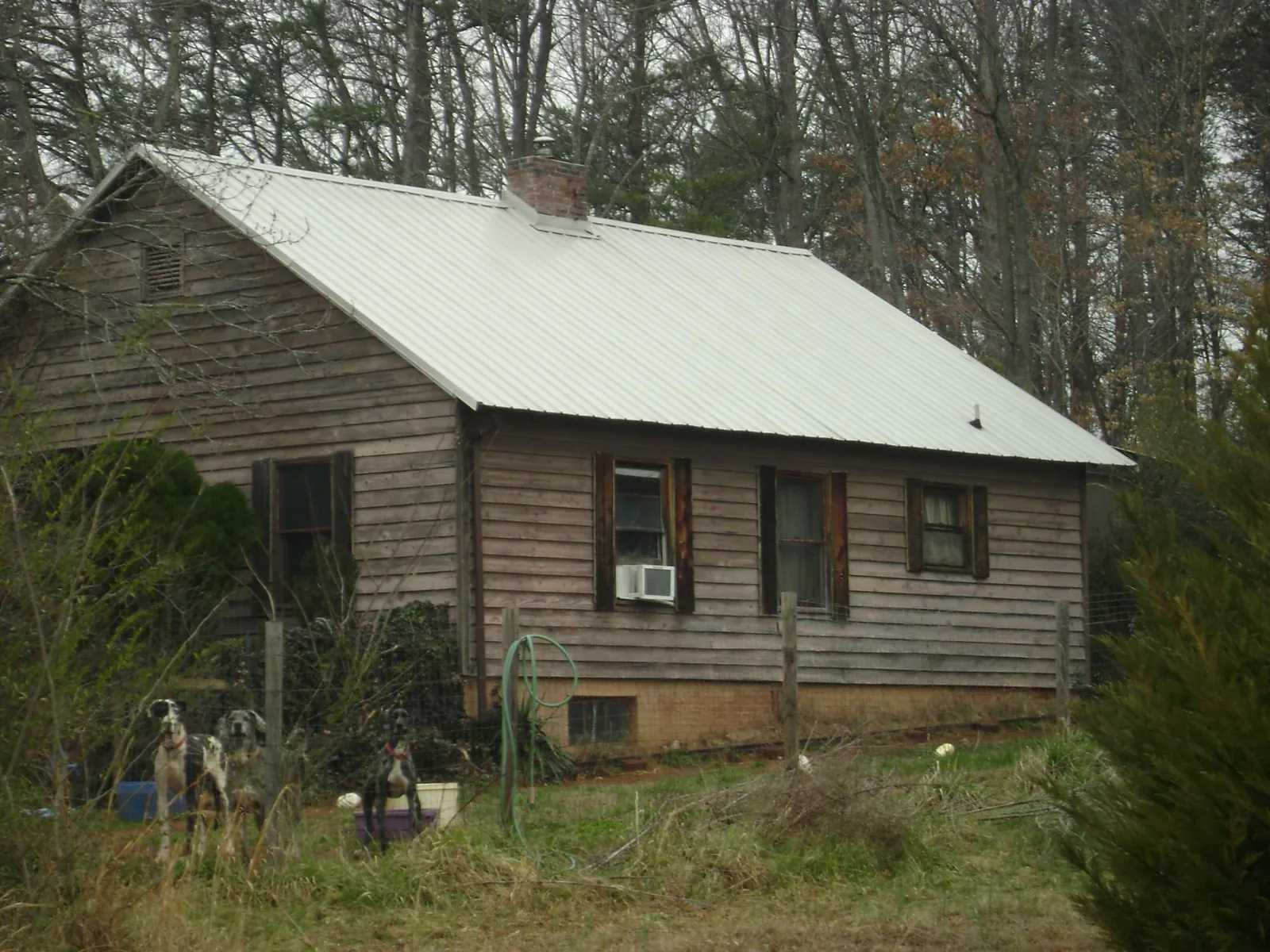 White metal roof on an old wood sided farmhouse, from a Metal Roof Installation job in Palmdale